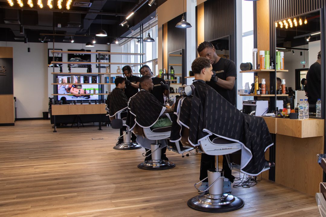 Barber working on client at Freddy Classics